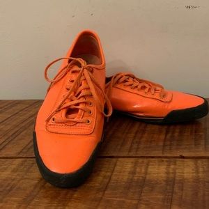 Neon orange PF Flyers sneakers.